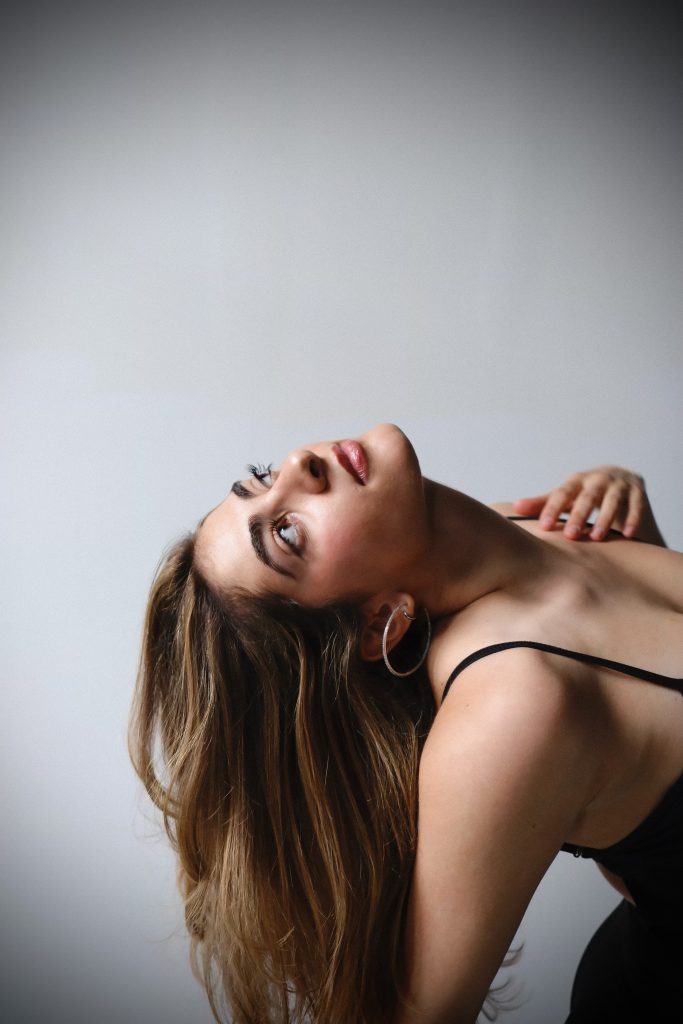 Long lived-in balayage with soft waves, studio portrait