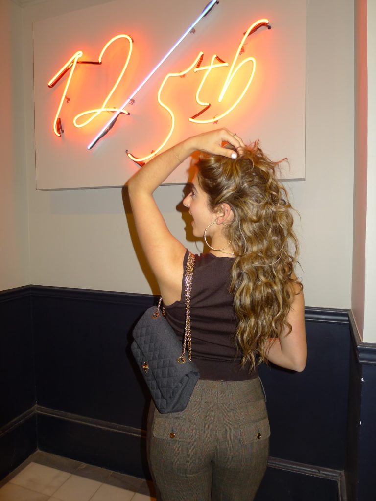 Long voluminous curls with caramel highlights, seen from behind